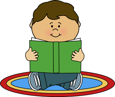 Smiling child sitting cross-legged on a colorful rug, reading a green book.