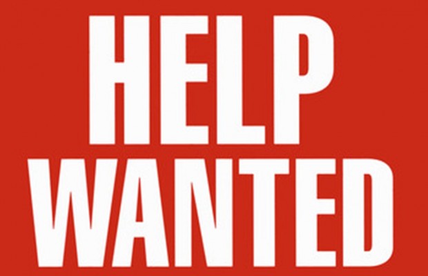 Bold white "HELP WANTED" text on solid red background, high-contrast job recruitment sign.