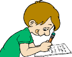 A young boy with brown hair in a green shirt concentrates while writing with a pencil on paper.
