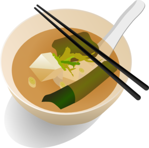 A steaming bowl of miso soup with tofu, green onions, and seaweed, served with chopsticks and a spoon.