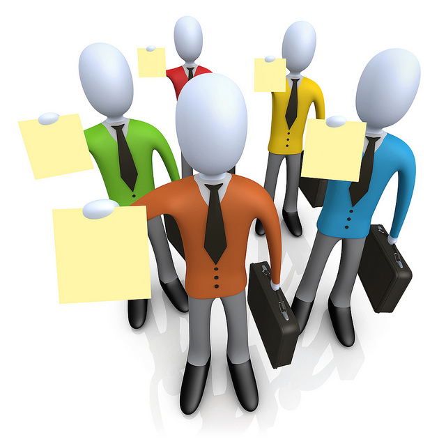 Five stylized business figures in colorful suits holding sticky notes and briefcases, symbolizing teamwork and planning.