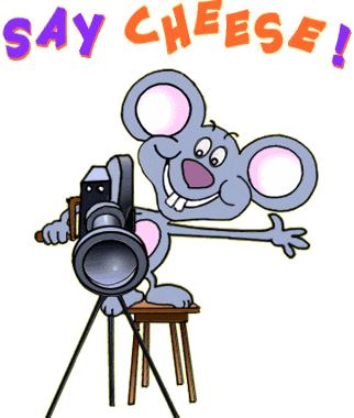 A cheerful cartoon mouse holding a camera on a tripod, with "SAY CHEESE!" text above.