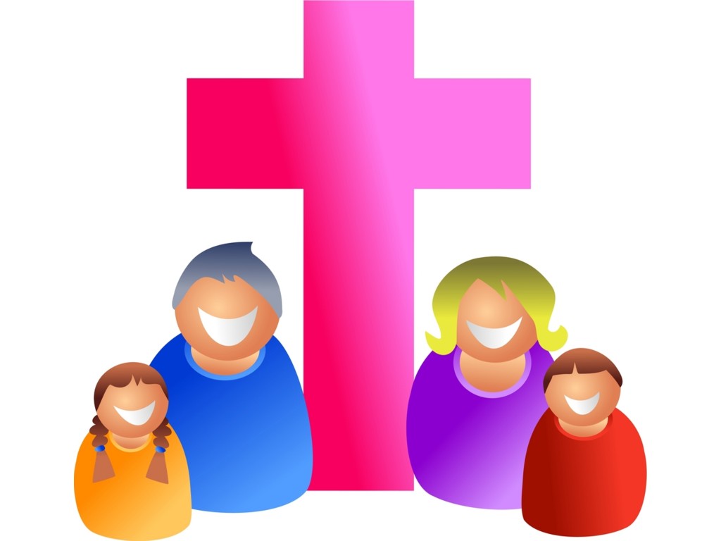 Smiling family of four standing before a pink Christian cross, symbolizing faith and unity.