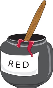 A gray jar labeled "RED" with vibrant red paint dripping down the side and a wooden stirrer inserted.