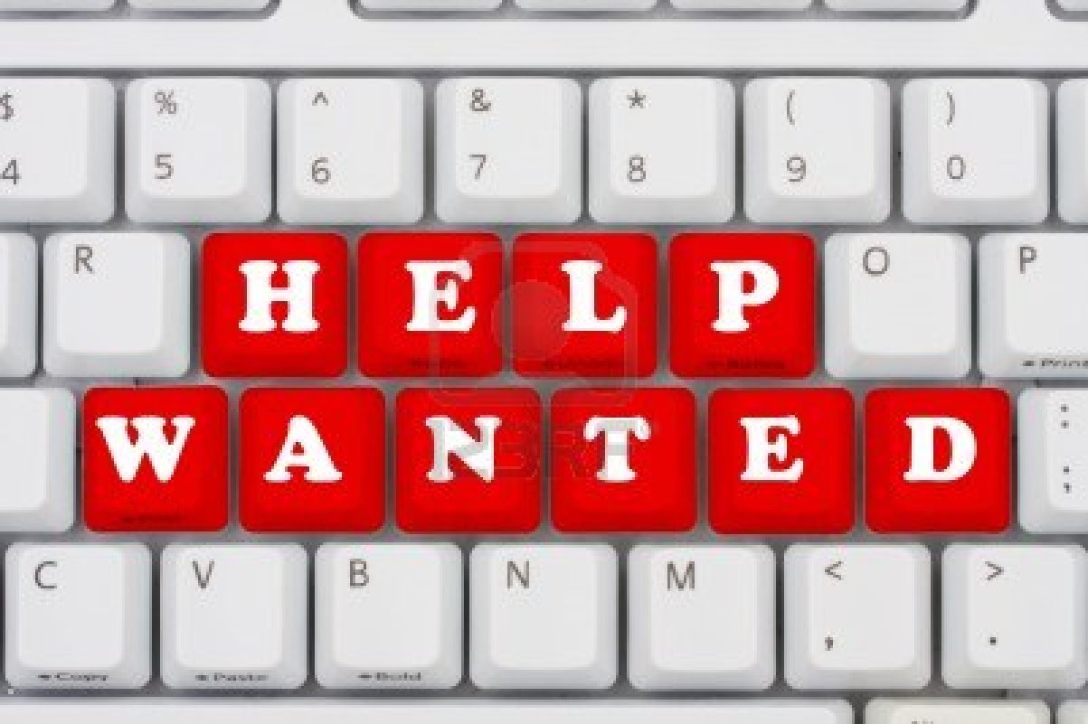 White keyboard with red keys spelling "HELP WANTED" in bold white letters.