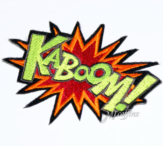 Embroidered "KABOOM!" comic-style explosion patch with green text, red-orange burst, and black outline.