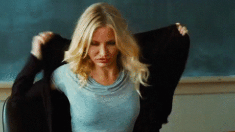 Woman Removing Sweater in Classroom Setting - Lifestyle & Fashion Image