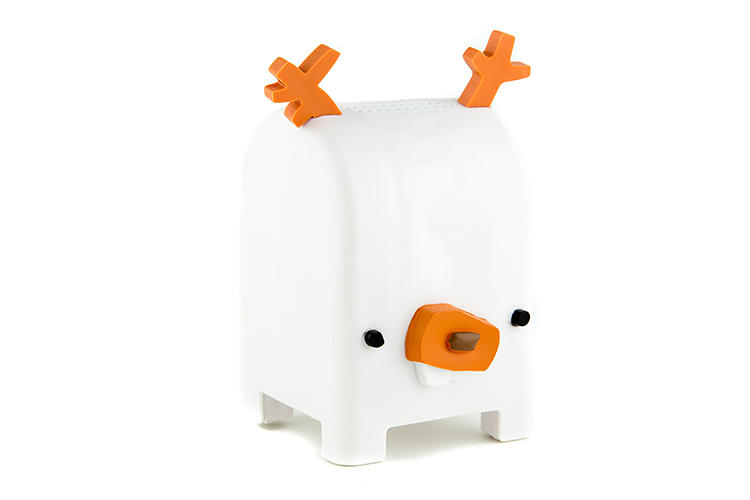White ceramic reindeer-shaped salt shaker with orange antlers, nose, and black eyes on a clean white background.