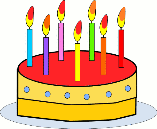 Colorful birthday cake with seven lit candles on a plate