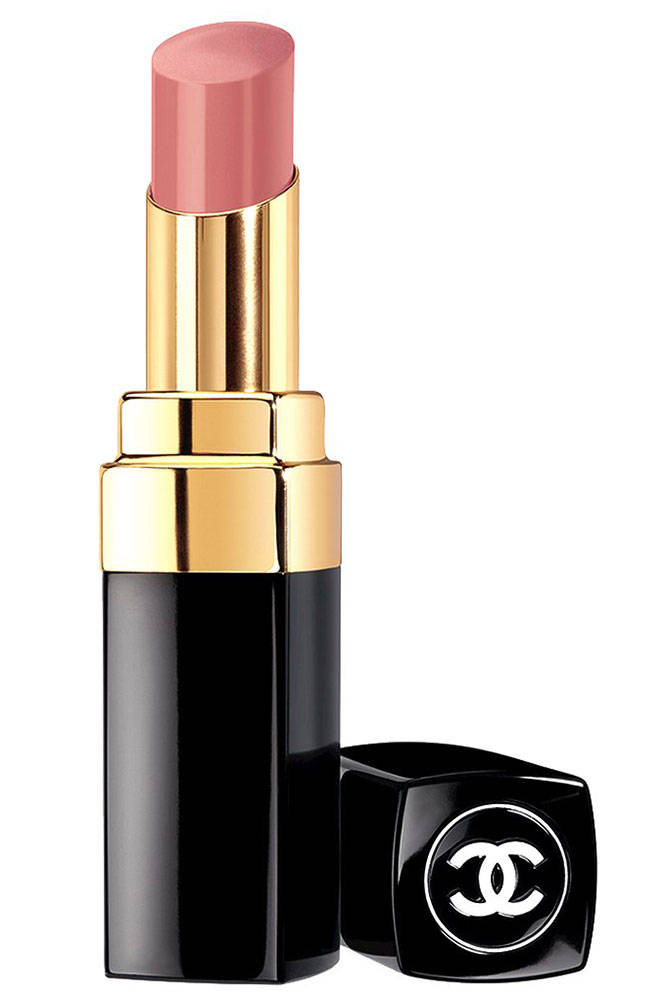 Chanel Rouge Coco lipstick in soft pink shade with iconic black and gold packaging, cap placed beside it on white background.