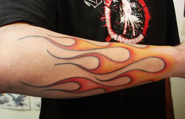Minimalistic red flame tattoo located on the inner