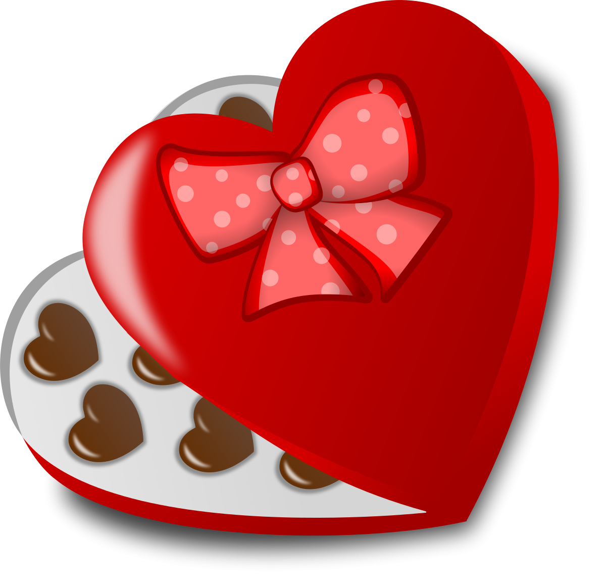 Red heart-shaped chocolate box with polka-dot bow, open to reveal chocolate hearts inside.