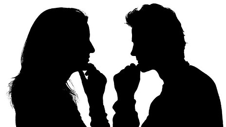 Silhouette of a man and woman in deep conversation, facing each other with thoughtful gestures.