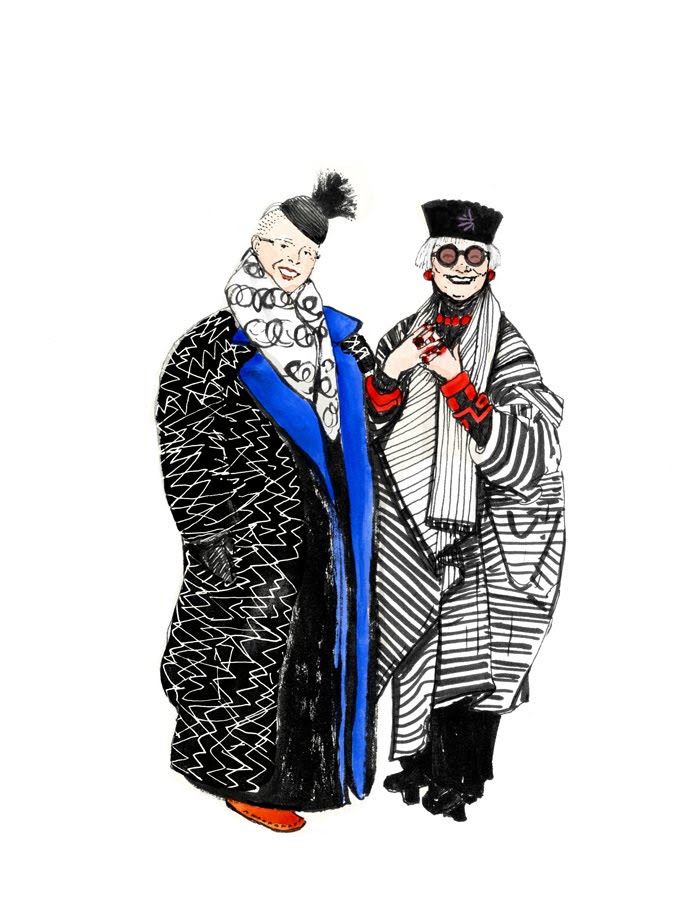 Two stylish elderly women in bold, patterned winter coats and accessories, smiling and posing together.