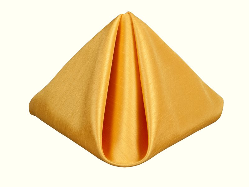 Golden satin napkin folded into a elegant pyramid shape on white background.