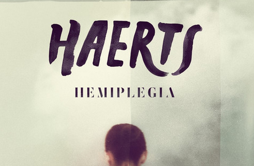 Album cover for "Haerts - Hemiplegia" featuring bold hand-painted typography and a blurred silhouette of a person from behind.