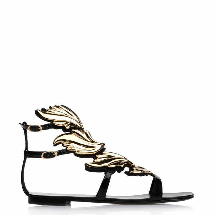 Black flat sandal with ornate gold leaf-shaped embellishments and thin straps.