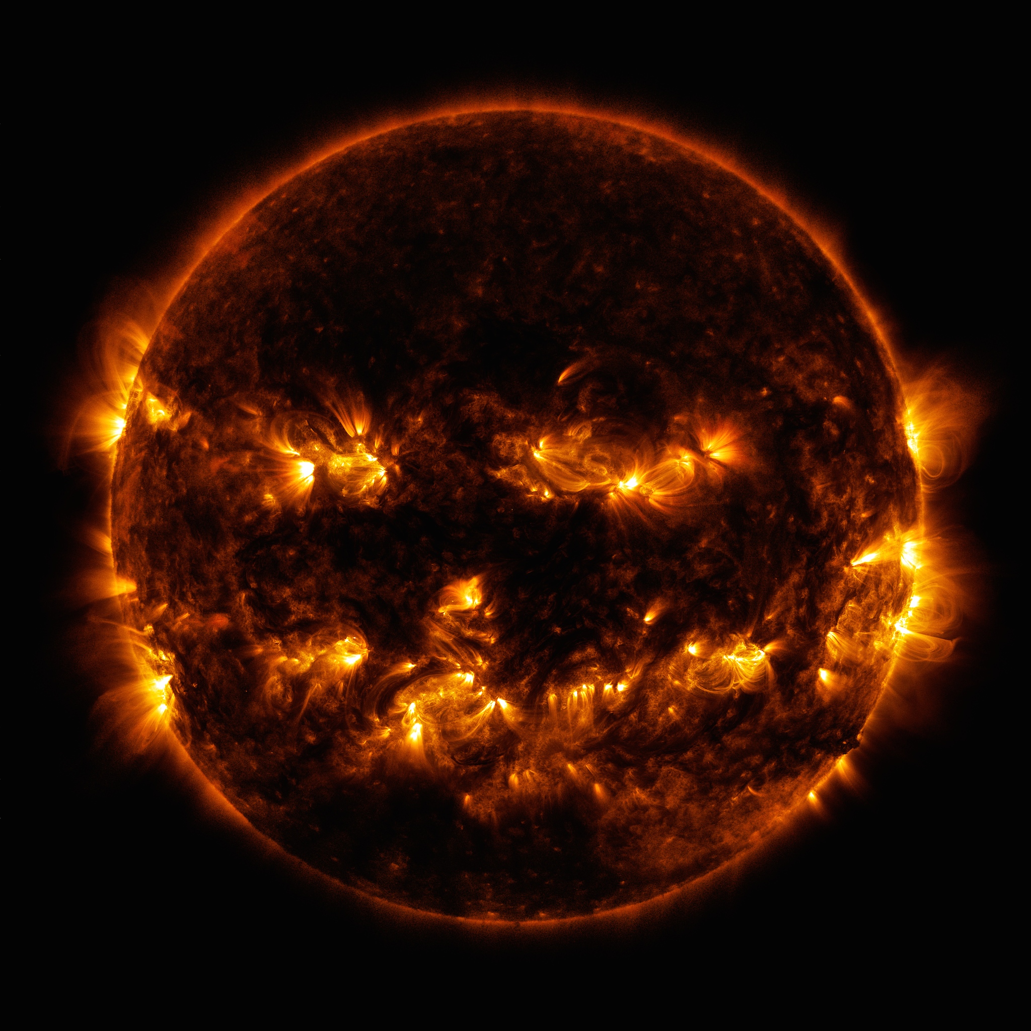 High-resolution image of the Sun showing intense solar flares and coronal loops against a black space background.