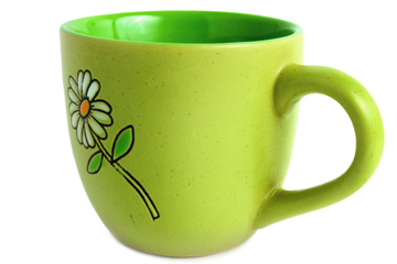 Bright lime-green ceramic mug with a hand-painted white daisy and green stem on its side, set against a white background.