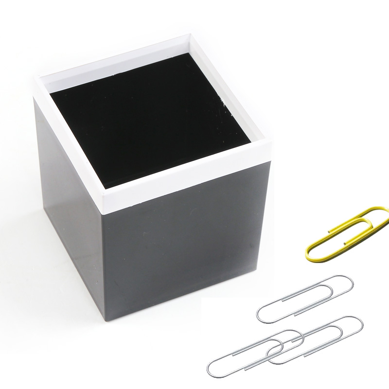 Modern black-and-white desktop organizer with paper clips on white background