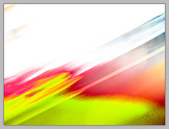 Abstract motion blur with vibrant red, yellow, green, and blue streaks on white background
