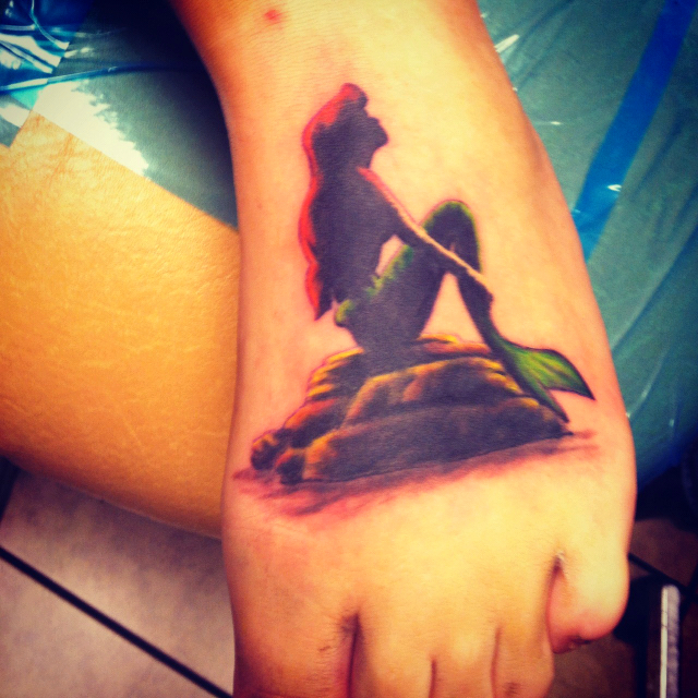 The Little Mermaid silhouette tattoo. Not sure on the color 