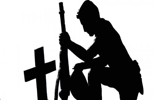 soldier kneeling at grave silhouette