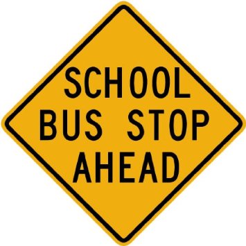 Yellow diamond-shaped traffic sign warning "SCHOOL BUS STOP AHEAD" in black uppercase letters.