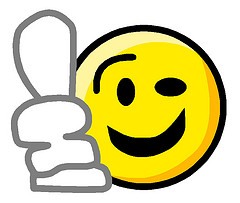 Yellow smiley face emoji giving a thumbs-up gesture, symbolizing approval or positivity.
