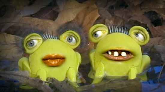 Two whimsical yellow claymation frogs with exaggerated eyes and lips peeking from leafy water.