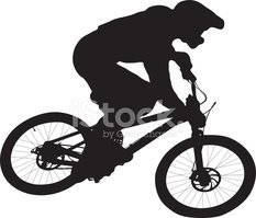 Silhouette of a cyclist riding a mountain bike in motion