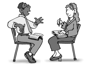 Two people engaged in a conversation, one gesturing while speaking and the other taking notes with a pen and notebook.