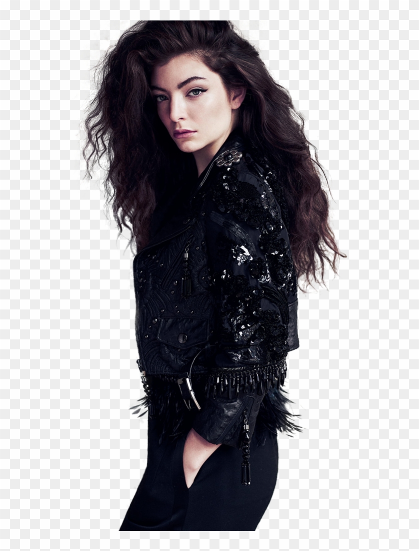 A woman with long dark wavy hair wearing a black embellished leather jacket with sequins and fringe, posing against a transparent background.